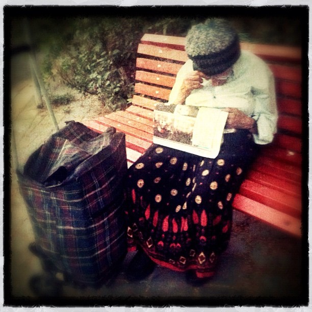 Old woman struggling to read